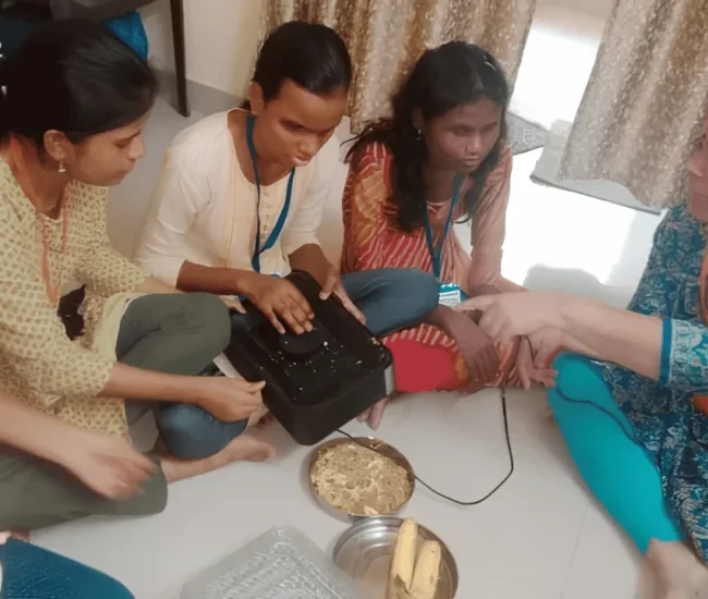 Hands of volunteers assisting a participant during a practical support activity.